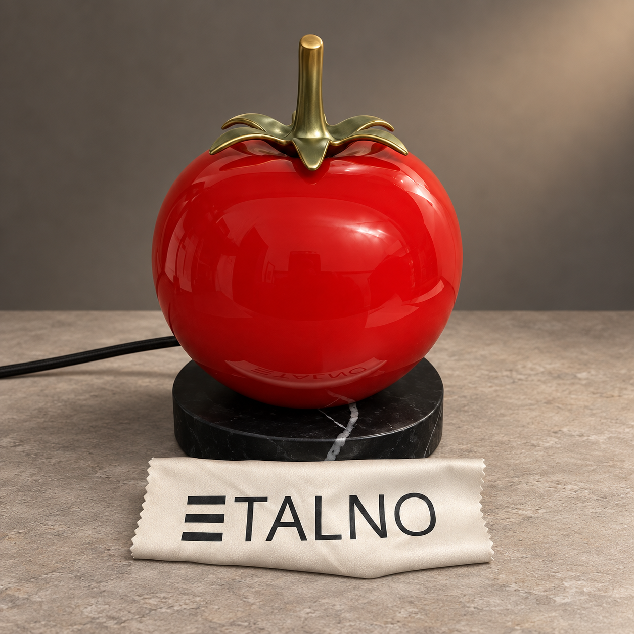 Red Glomato lamp with a gold stem, black marble-effect base and ETALNO cloth